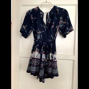 Navy blue and pink floral romper, worn once. Trixxi clothing company. Size S